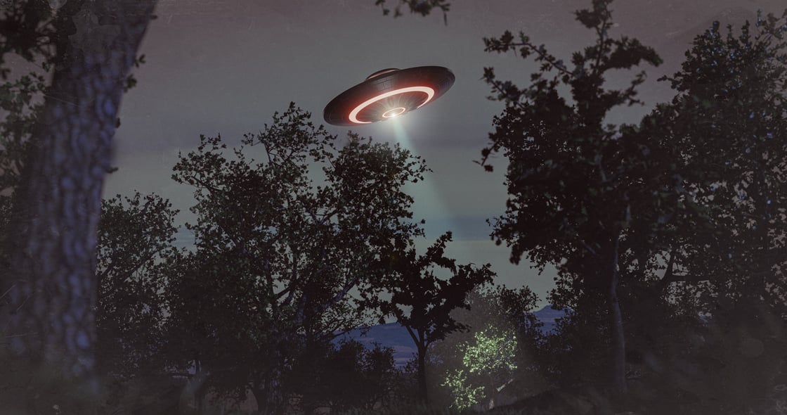 UFO flies over the forest - concept 3D illustration. iStock/guteksk7